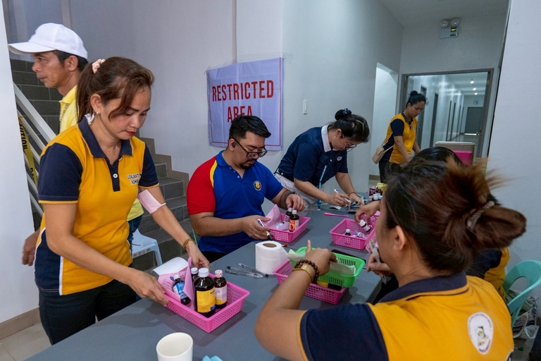 As lines for medicine distribution grew longer, volunteers worked with precision to assist waiting patients.