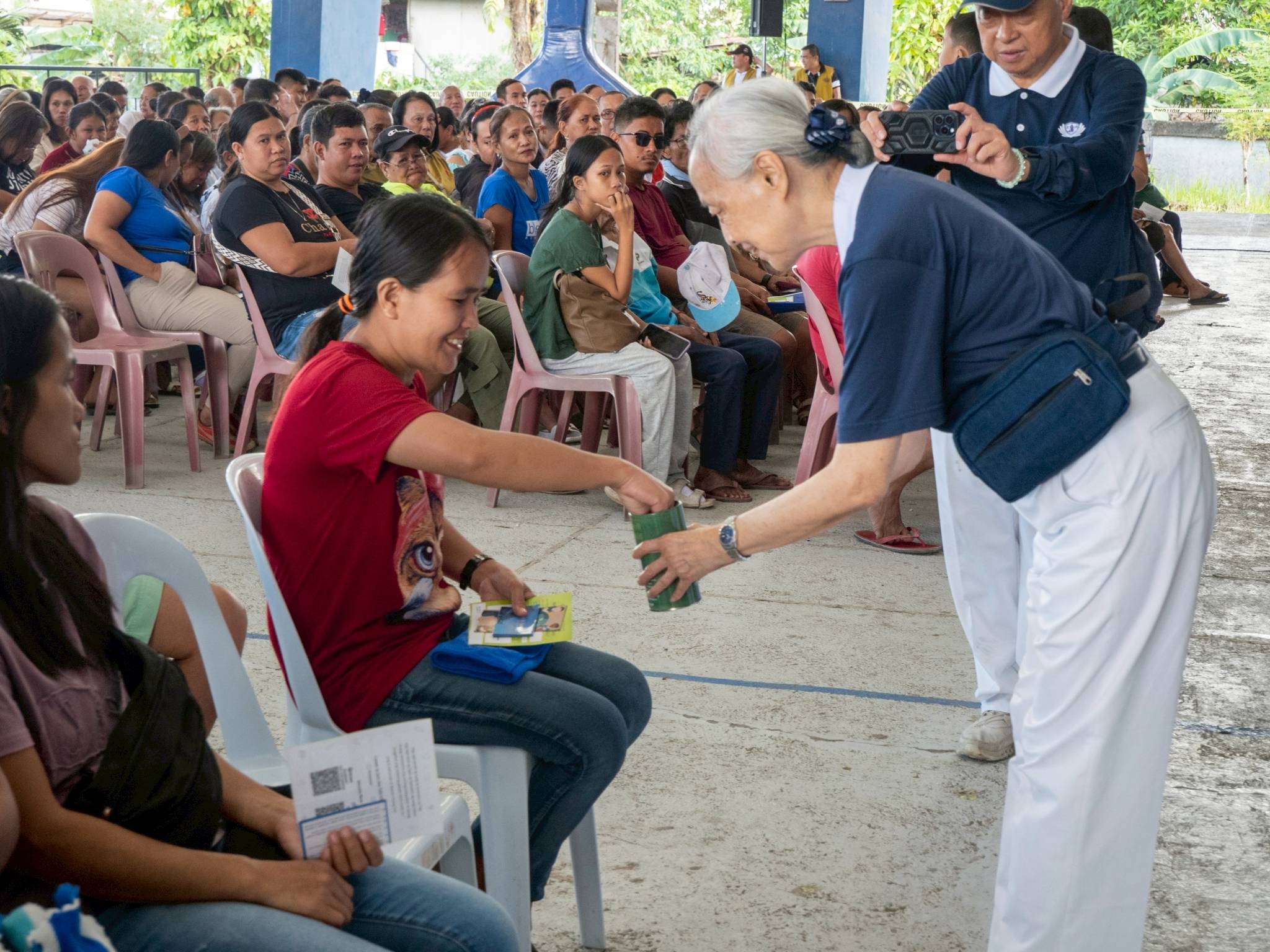 Tzu Chi volunteers accept donations from beneficiaries, a practice to show that even in the face of loss, a calamity victim still has the capacity to help.