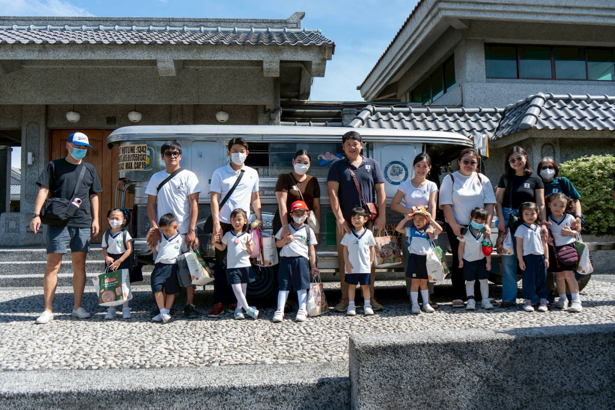 Kuya Ronald, the driver, poses with the students and their parents after a fun, safe ride.