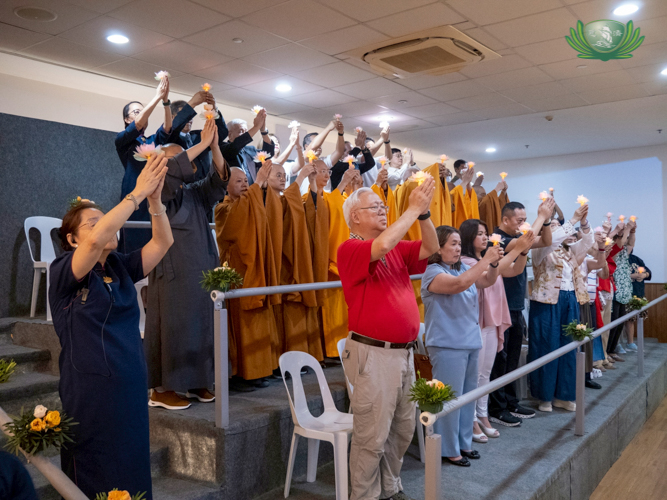 The Buddha Bathing ceremony ends with participants raising their lighted lotus flowers as a sign of love and respect to the Buddha.