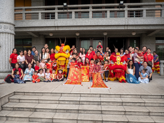 Preschoolers, their parents, and teachers gather for a group shot following a successful celebration and learning experience of Chinese New Year and culture.