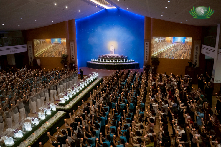 The Buddha Bathing ceremony ends with participants raising their lighted lotus flowers as a sign of love and respect to the Buddha.