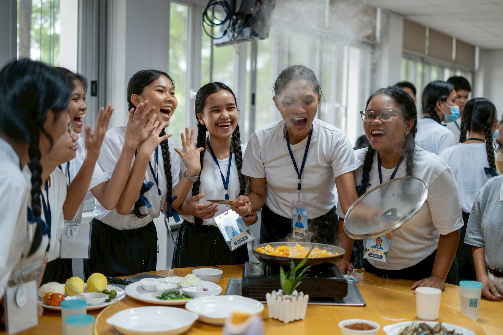Scholars savor the aroma of their squash in coconut milk. 