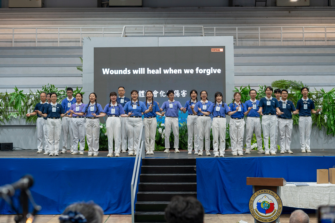 Taiwan-based Tzu Chi Youth volunteers, alongside their mentors, deliver a heartfelt sign language performance on stage.