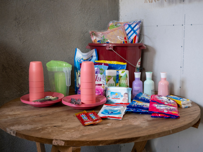 Gifts for the residents include essentials such as toiletries, cups and utensils, tablecloths, and other needs.