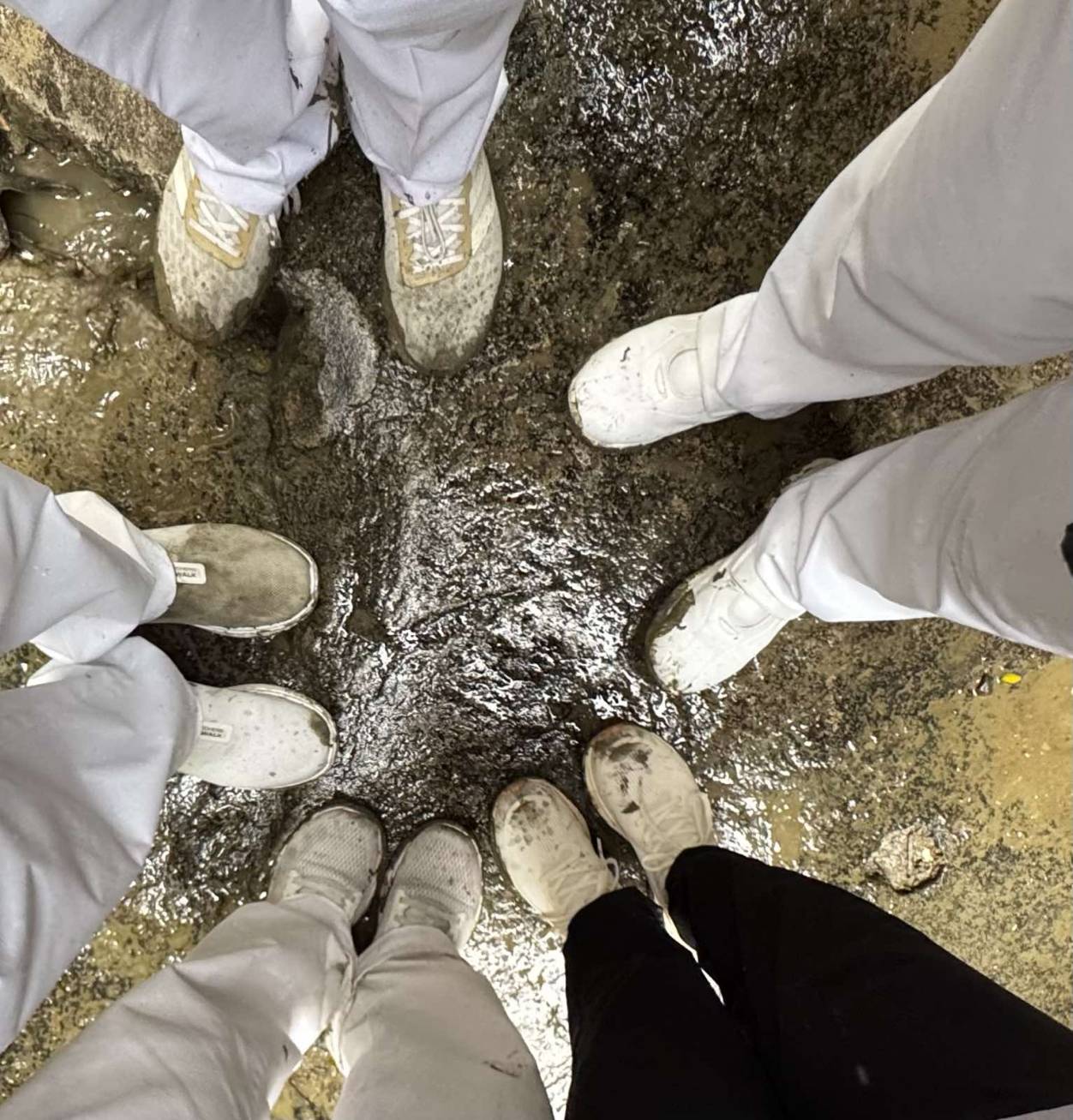 After a day of distributing provisions and other forms of assistance, Tzu Chi volunteers’ white sneakers are splattered with mud.