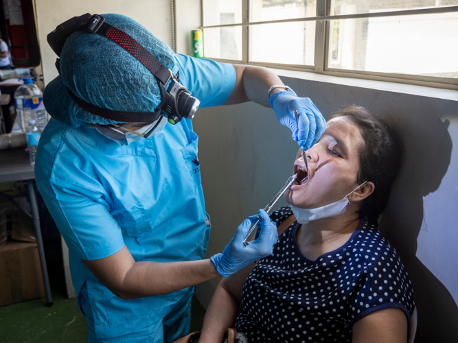 A patient undergoes tooth extraction.