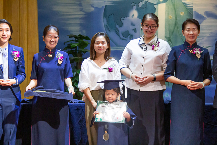 Flanked by Tzu Chi commissioners and special guests, parents pose proudly with their kids in the second moving up ceremony of Tzu Chi Great Love Preschool Philippines.