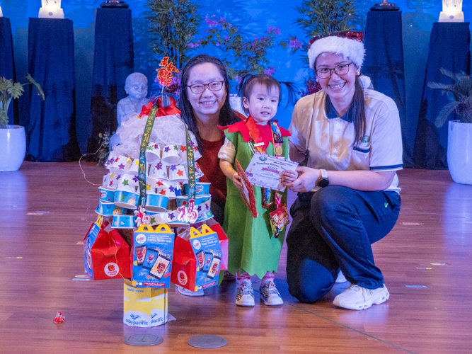 A student wins the Timeless Keeper award for using ice cream cups from her past birthday celebration to decorate her Christmas tree. It showed her dedication to saving recyclable items for future use.