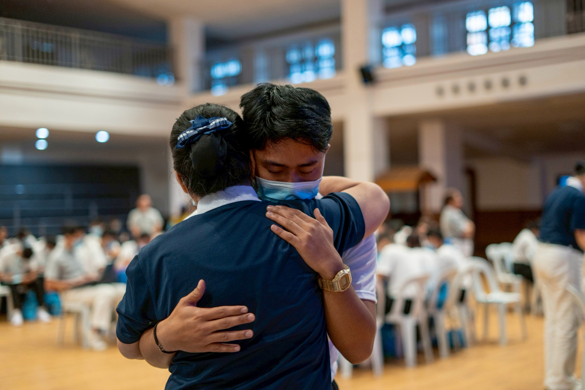Tzu Chi Zamboanga scholar Carll Maverick Salac gets a hug from a volunteer during a particularly emotional moment in “Filial Piety.”