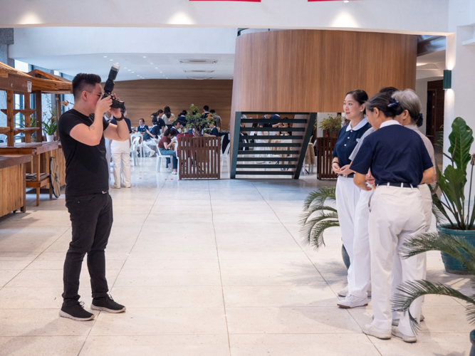 Capturing the spirit of community, volunteers gather in Unity Hall for a commemorative group photo, preserving memories of their shared celebration.