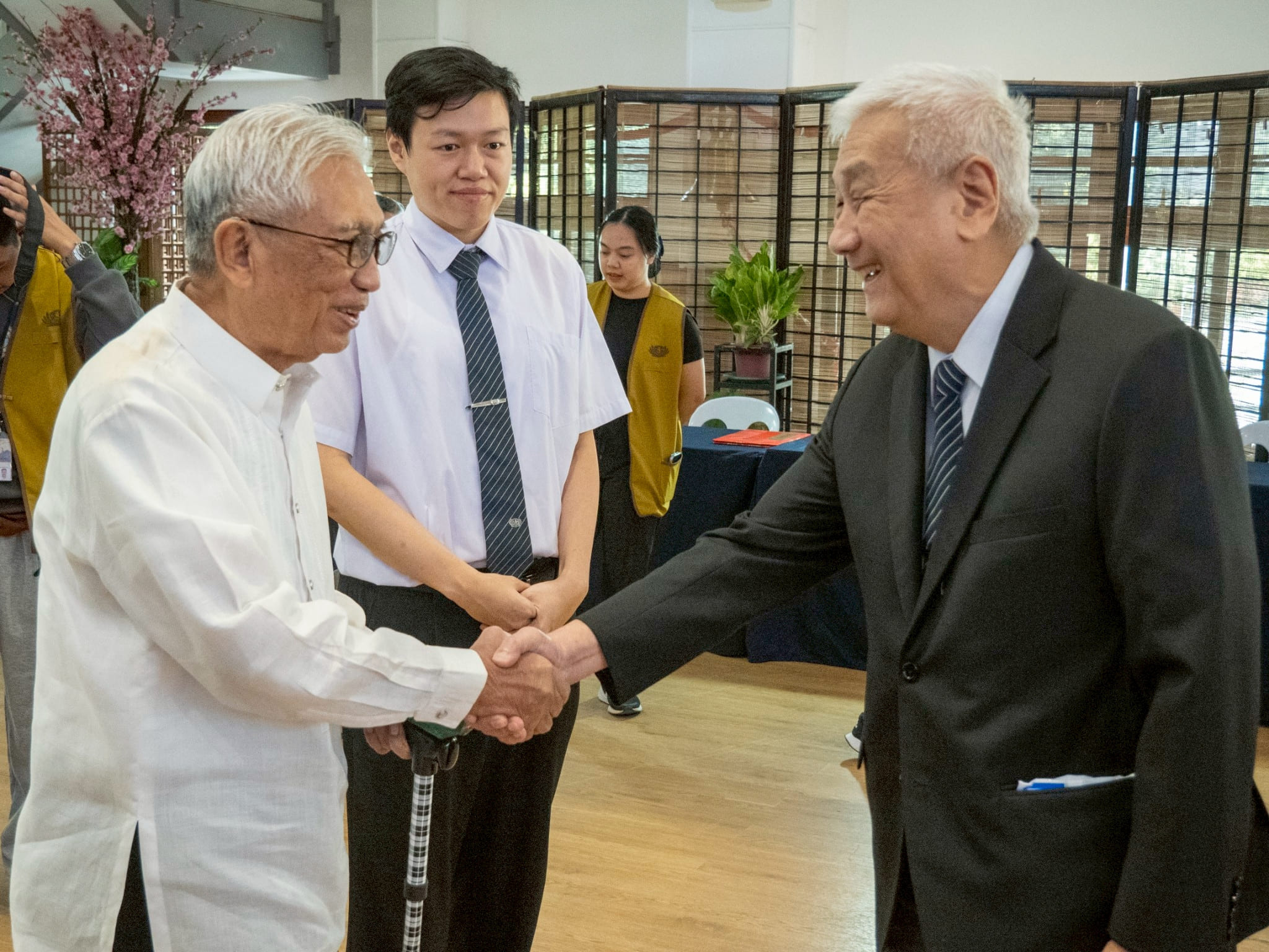 Former Department of Health Secretary Enrique Ona (left) is welcomed by Tzu Chi Philippines CEO Henry Yuñez as Tzu Chi Philippines Partnerships Officer Clifford Co (center) looks on.