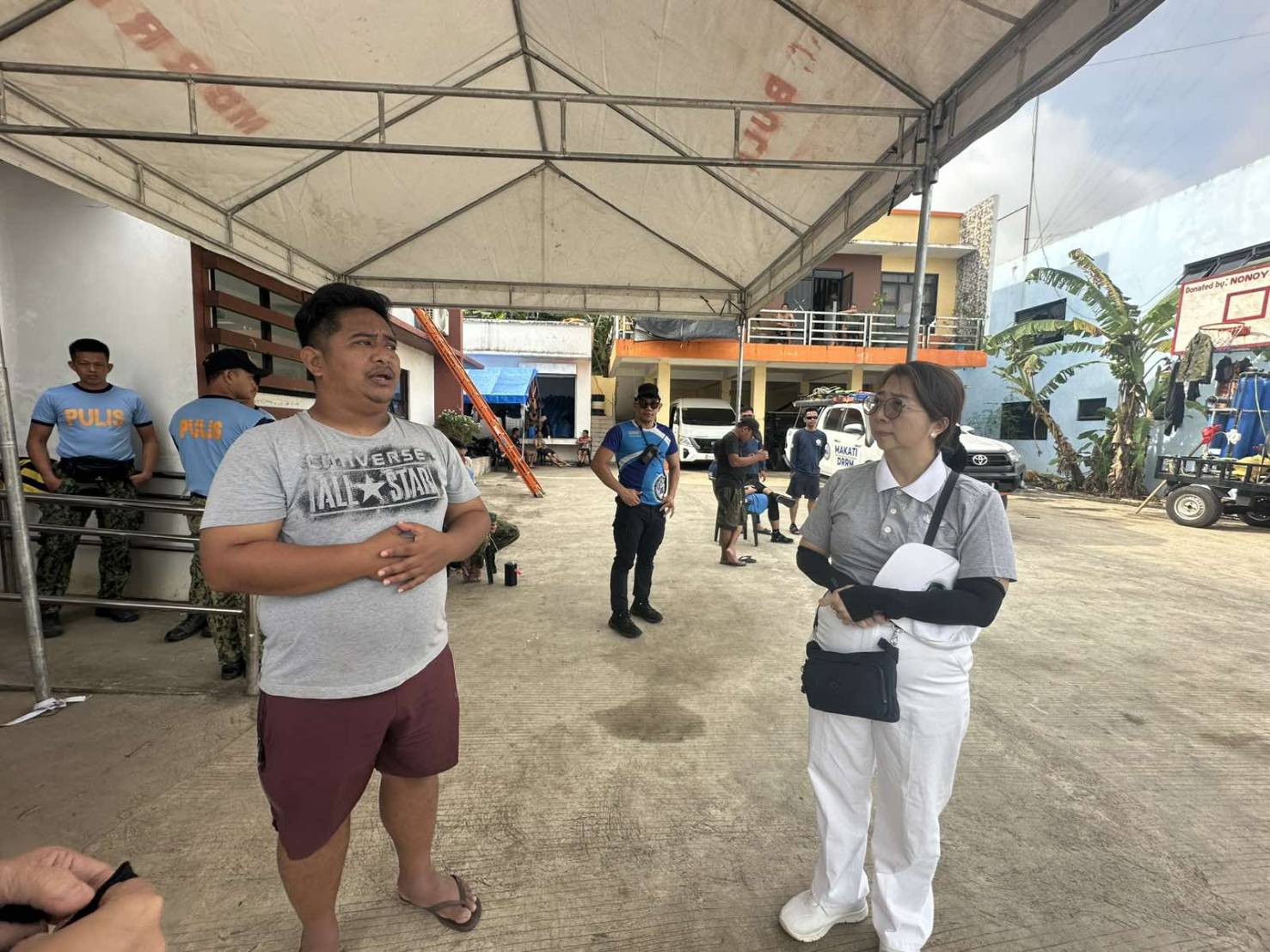 A Tzu Chi Bicol volunteer listens to accounts of the typhoon at the Municipal Disaster Risk Reduction and Management Council command center in Bula, Camarines Sur.