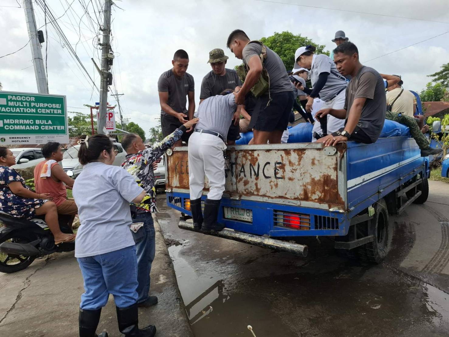 Struggling to travel to nearby towns due to flooding, Tzu Chi volunteers accept a ride on the transport truck of the Municipal Disaster Risk Reduction and Management Council so they can distribute rice to evacuees. 