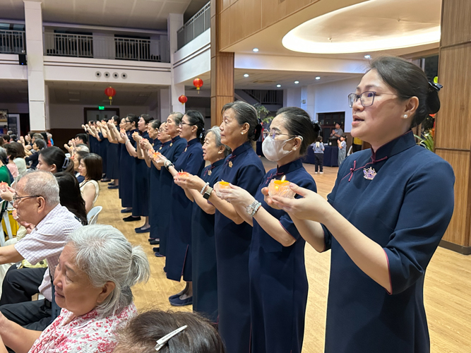 Participants raise their lotus candles in a united prayer for peace and harmony in the world.