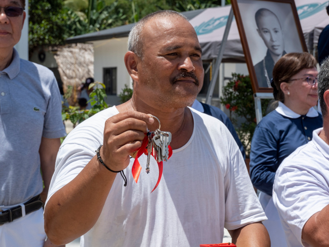 A recipient proudly shows his house keys.