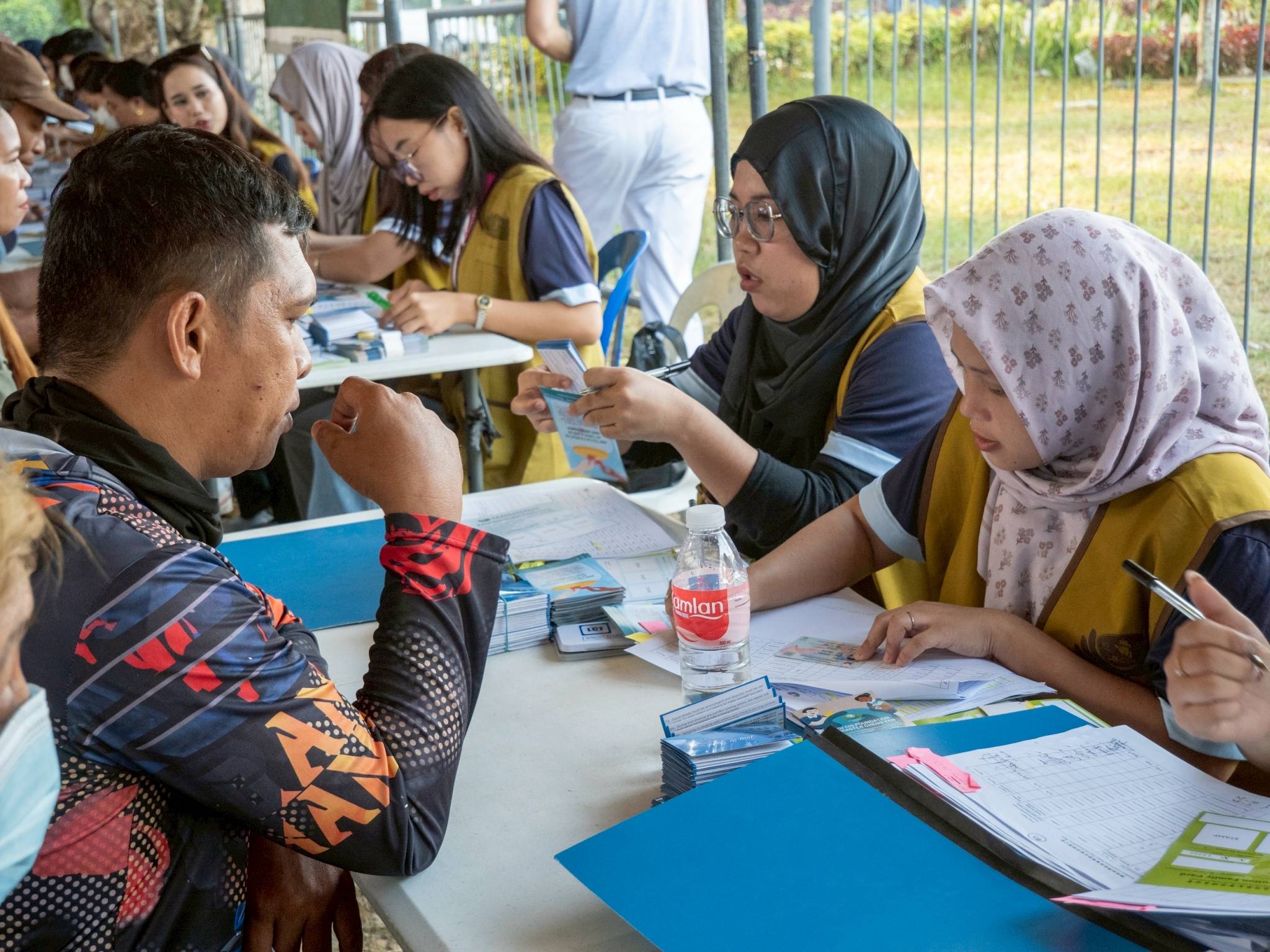 Social work students from Iligan Medical Center College work fast and efficiently at the registration.