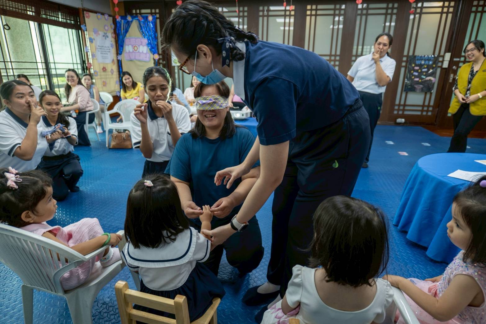 Excitement filled the room as a mom took part in a blindfold game, trying her best to identify  her child just by touching their hand.