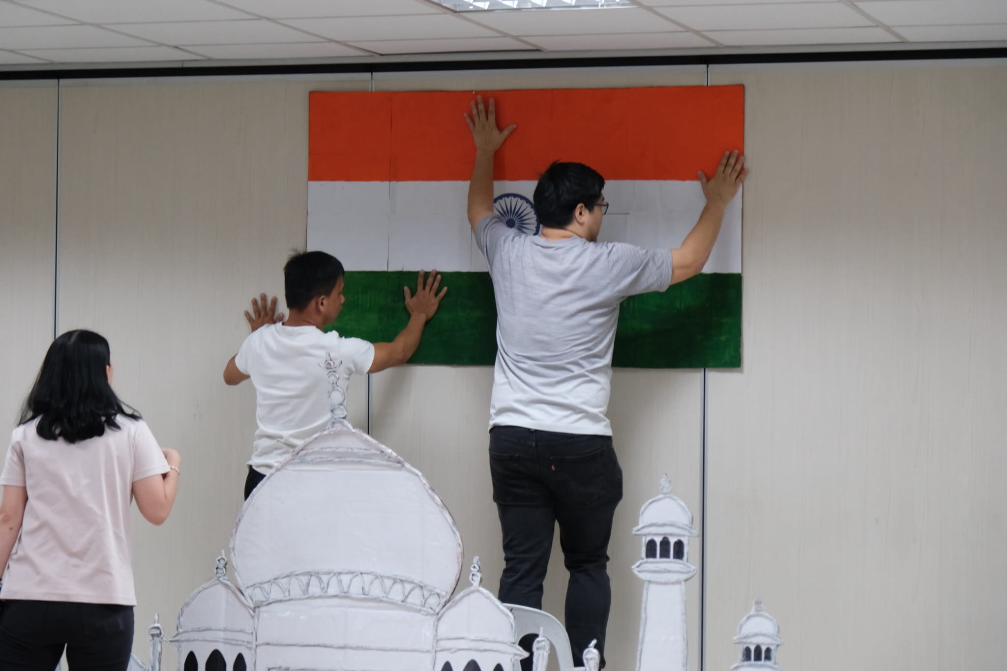 Parents work together behind the scenes to prepare their cultural booths. 