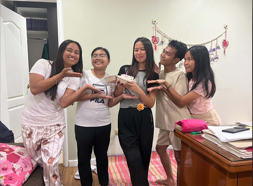 (Center) Celebrating her 20th birthday with cake and friends 
