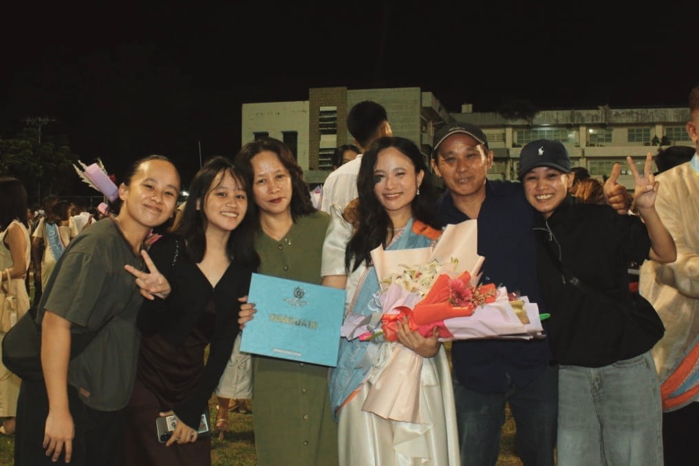 A complete family photo as they celebrate the first graduate of the family.
