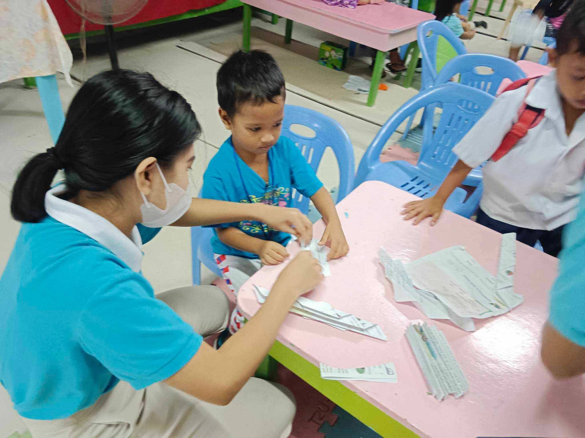 At Tzu Chi Palo Temporary Housing Village’s daycare center,  Shekinah Salazar spends time playing with kids.