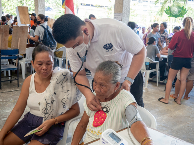 Tzu Chi scholar alumni and now a volunteer doctor Edil-Joshua Ganas helps provide medical consultations for the elderly.