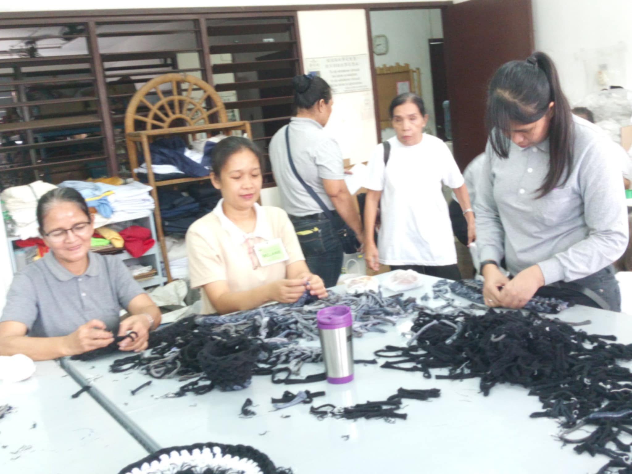 Apart from sewing lessons, scholars like Melani Mapili (second from left) gain knowledge on weaving used cloth as rugs.