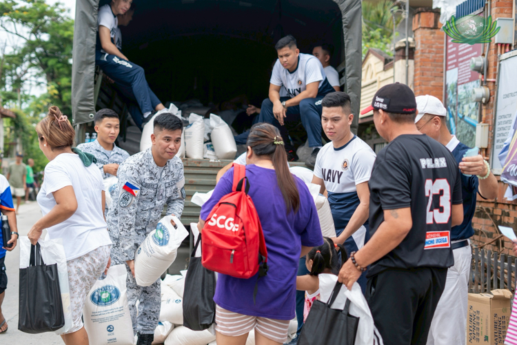 Members of the Philippine Navy help distribute the 10-kilogram sacks of rice to beneficiaries.