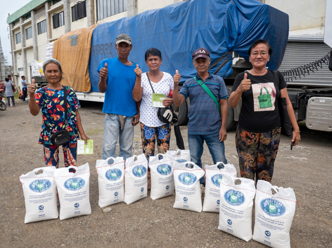 Beneficiaries say “thank you,” the Tzu Chi way, with their thumbs bowing.