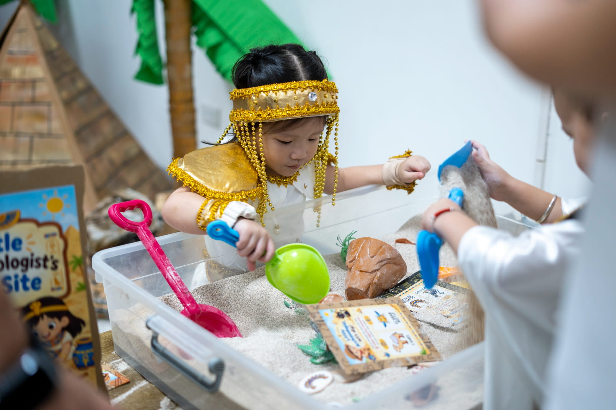Young explorers eagerly excavate hidden treasures and artifacts.