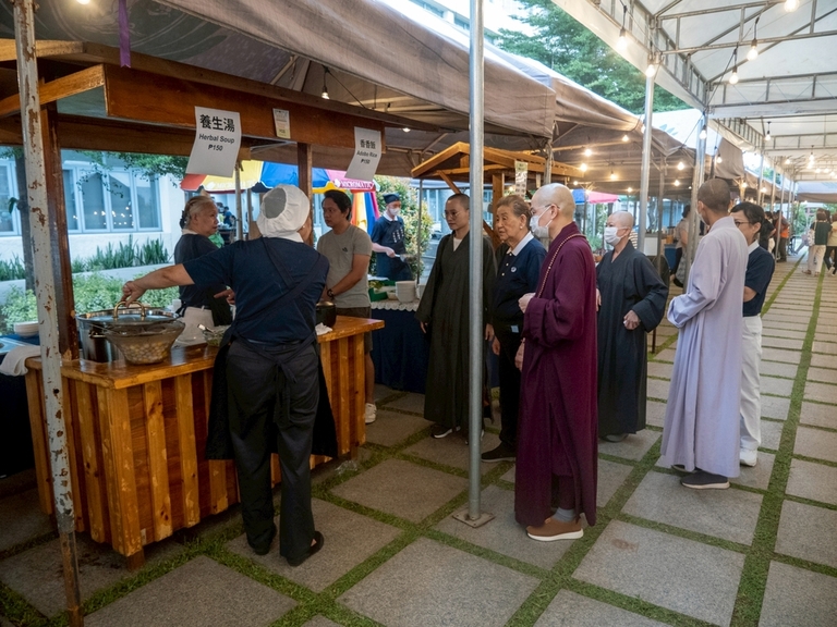 Buddhist monks check out the various vegetarian options at the plaza.