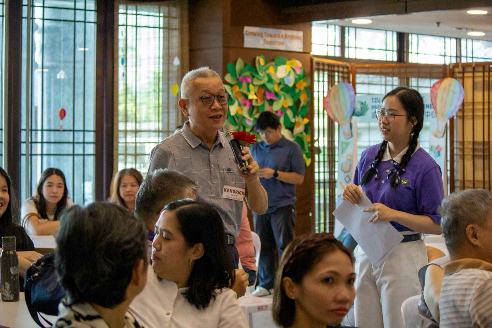 Sharing wisdom and warm memories,  grandparents draw questions from a box during an engaging ice-breaker activity.
