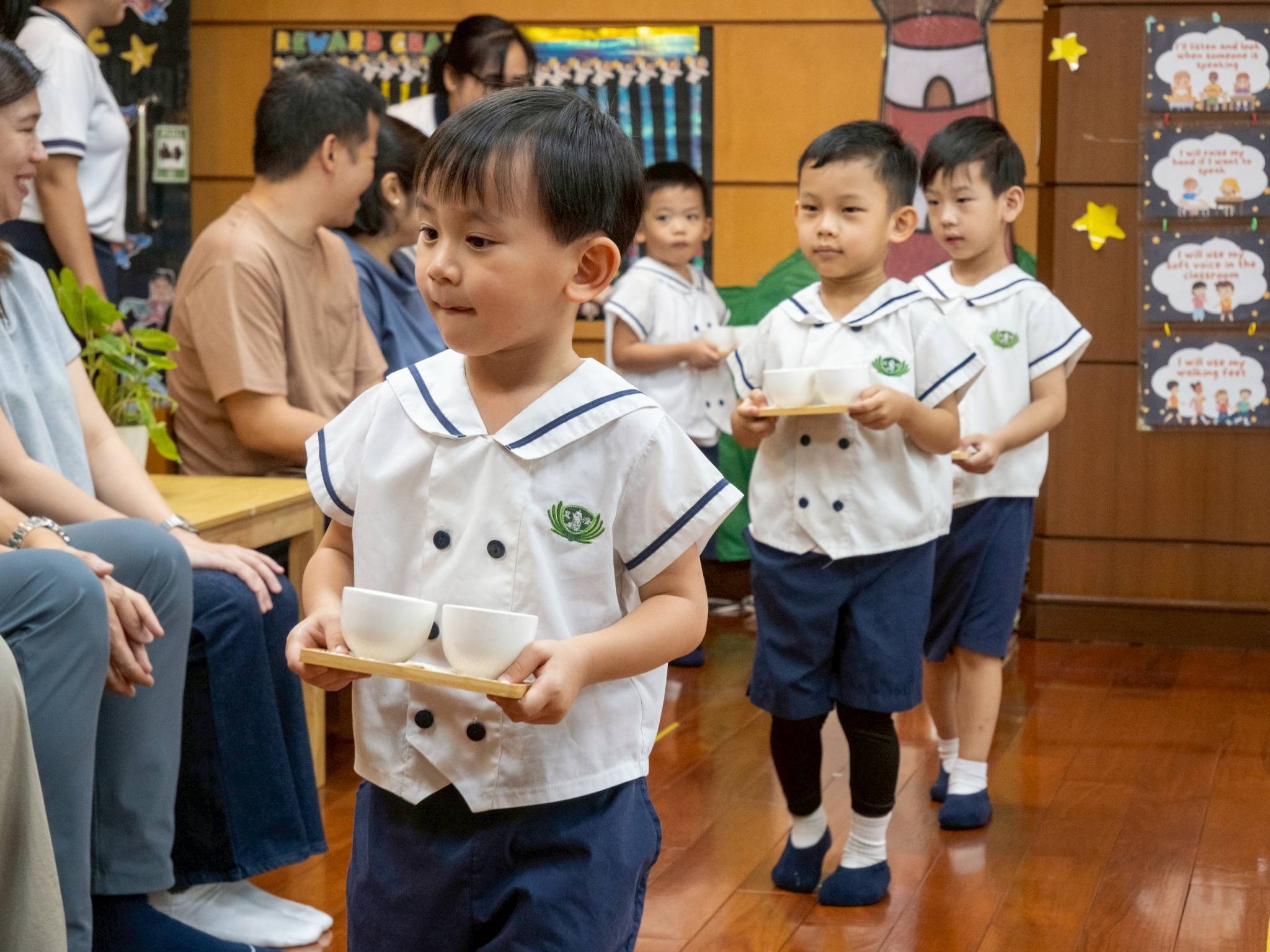 With steady hands and careful steps, they carried the tea cups, hoping to please their parents.