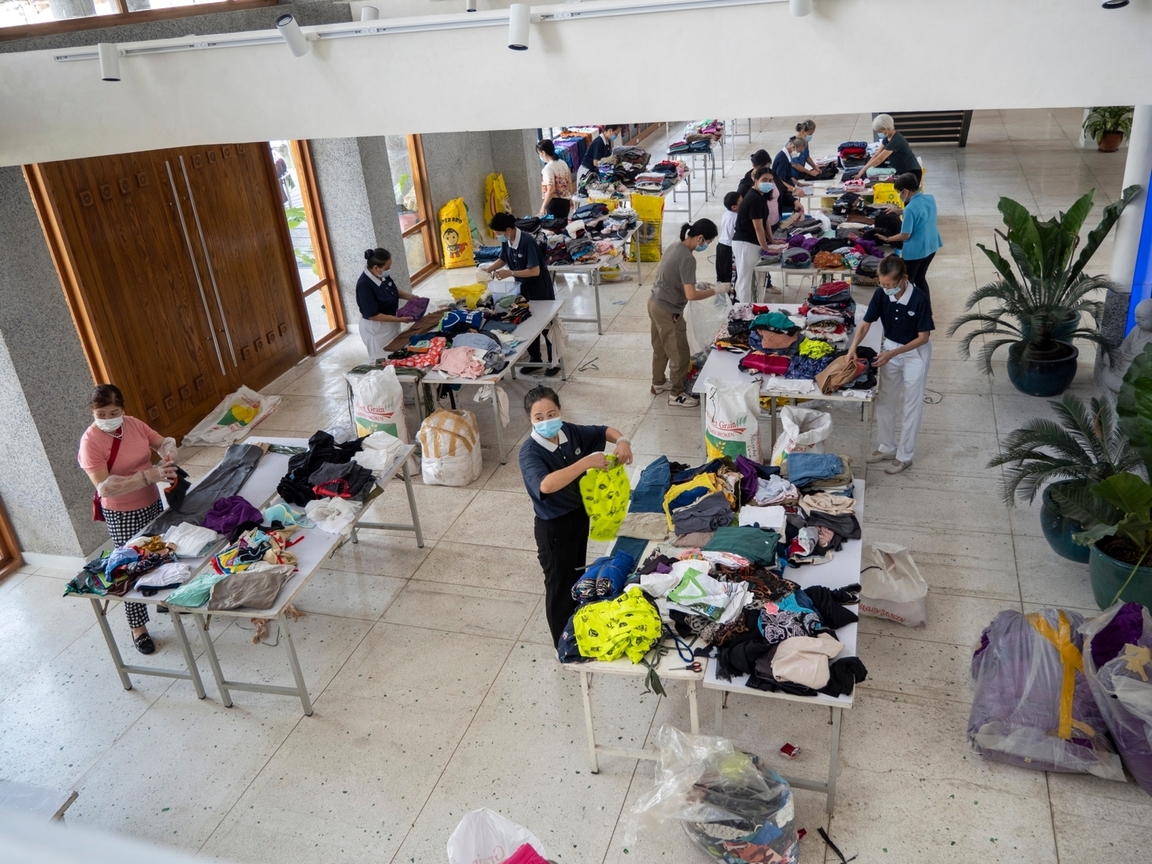 Volunteers met at Unity Hall in Buddhist Tzu Chi Campus to prepare bundles of donated clothes for distribution to communities affected by Typhoon Marce (Yinxing) in Aparri. 