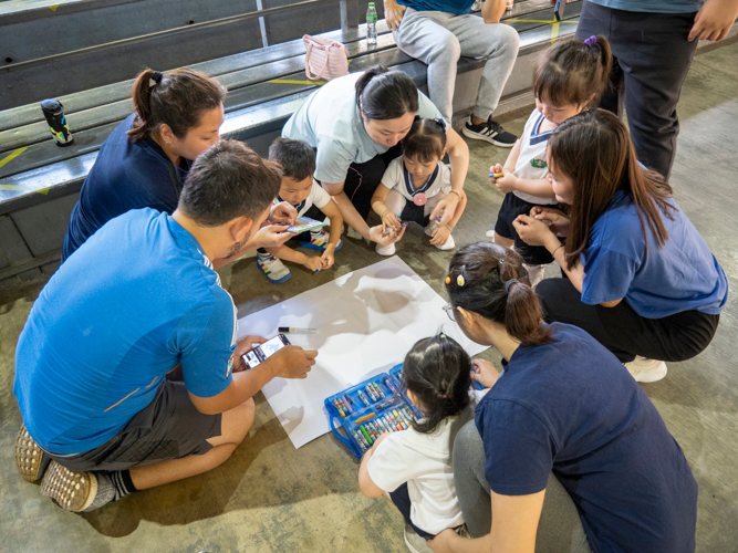 The team called “Blue Dolphins”   work together in making the ideal banner.