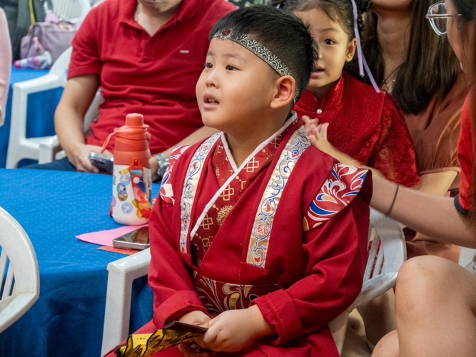 Preschoolers show up sporting their best Chinese attire. 