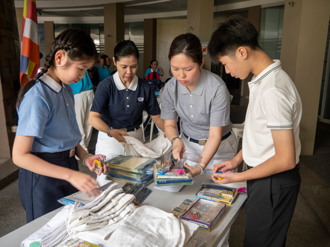 Tzu Chi volunteers sort through school supplies, part of the comprehensive donation package for Munting Tahanan ng Nazareth residents.