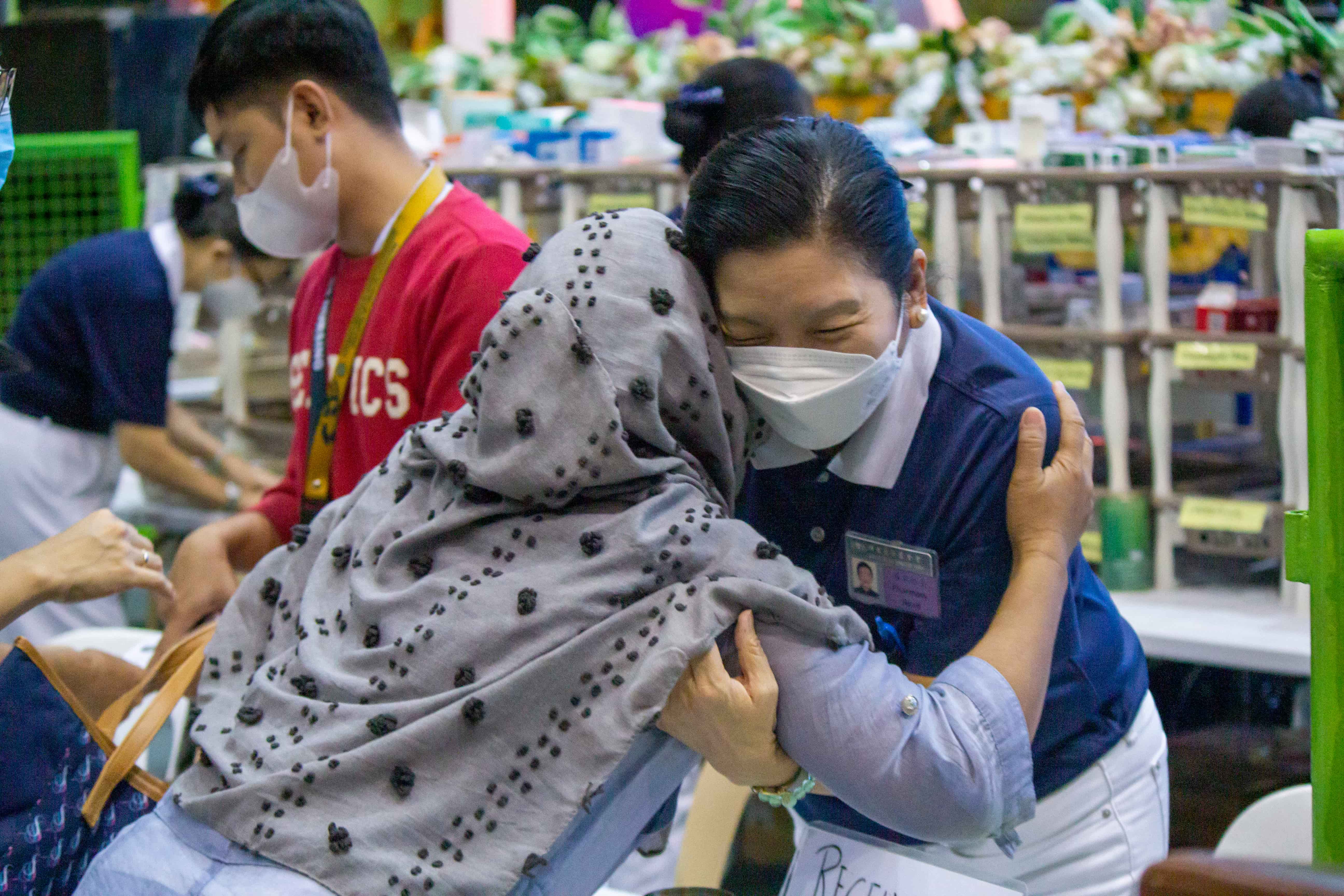 (Right) Hugging a grateful beneficiary at a medical mission in Sultan Kudarat