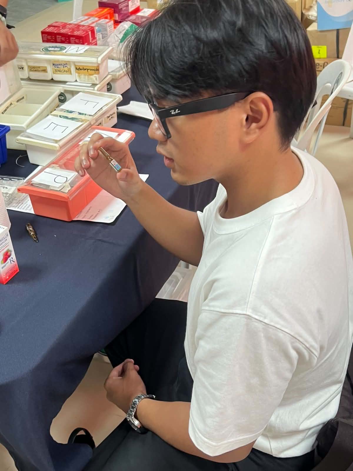 Gio Pamintuan assists with Visual Acuity Tests for patients undergoing eye consultations at Ateneo de Zamboanga University through the Angel of Sight Program.
