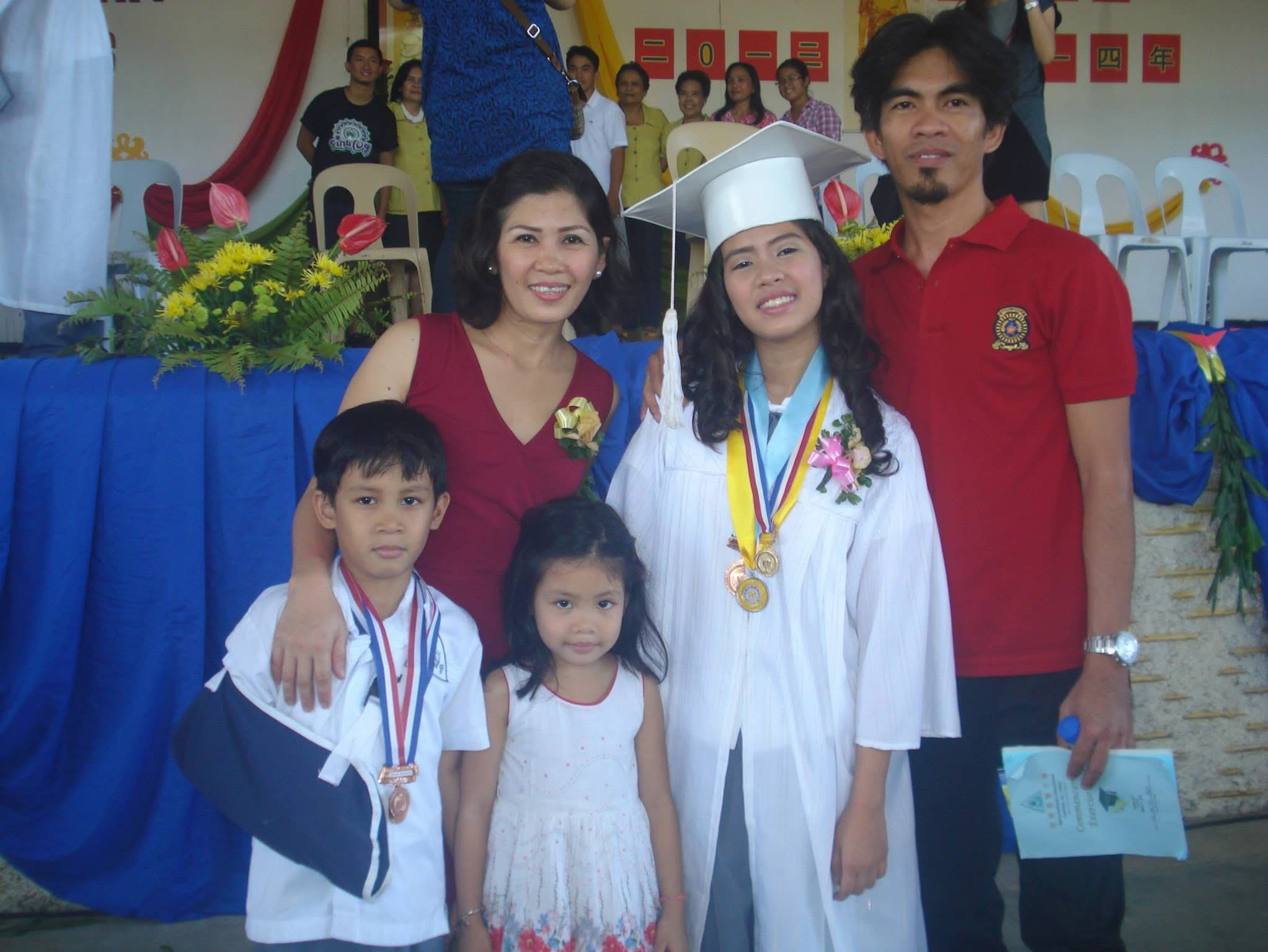 (Second from right) The consistent honor student celebrates her achievement with her family. 