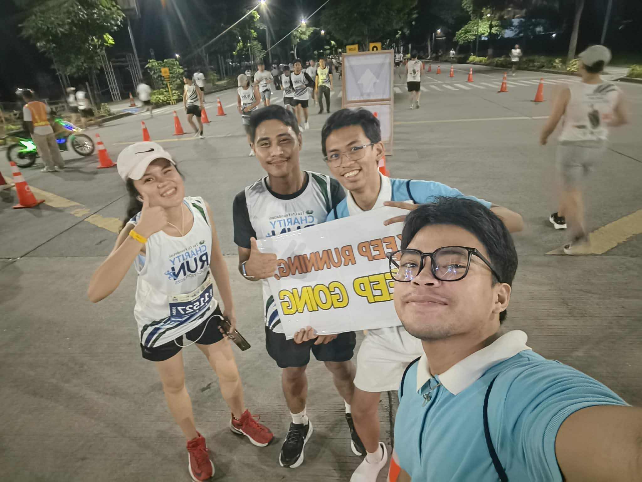 (Second from right) Cheering participants on at the Tzu Chi Charity Run for Education