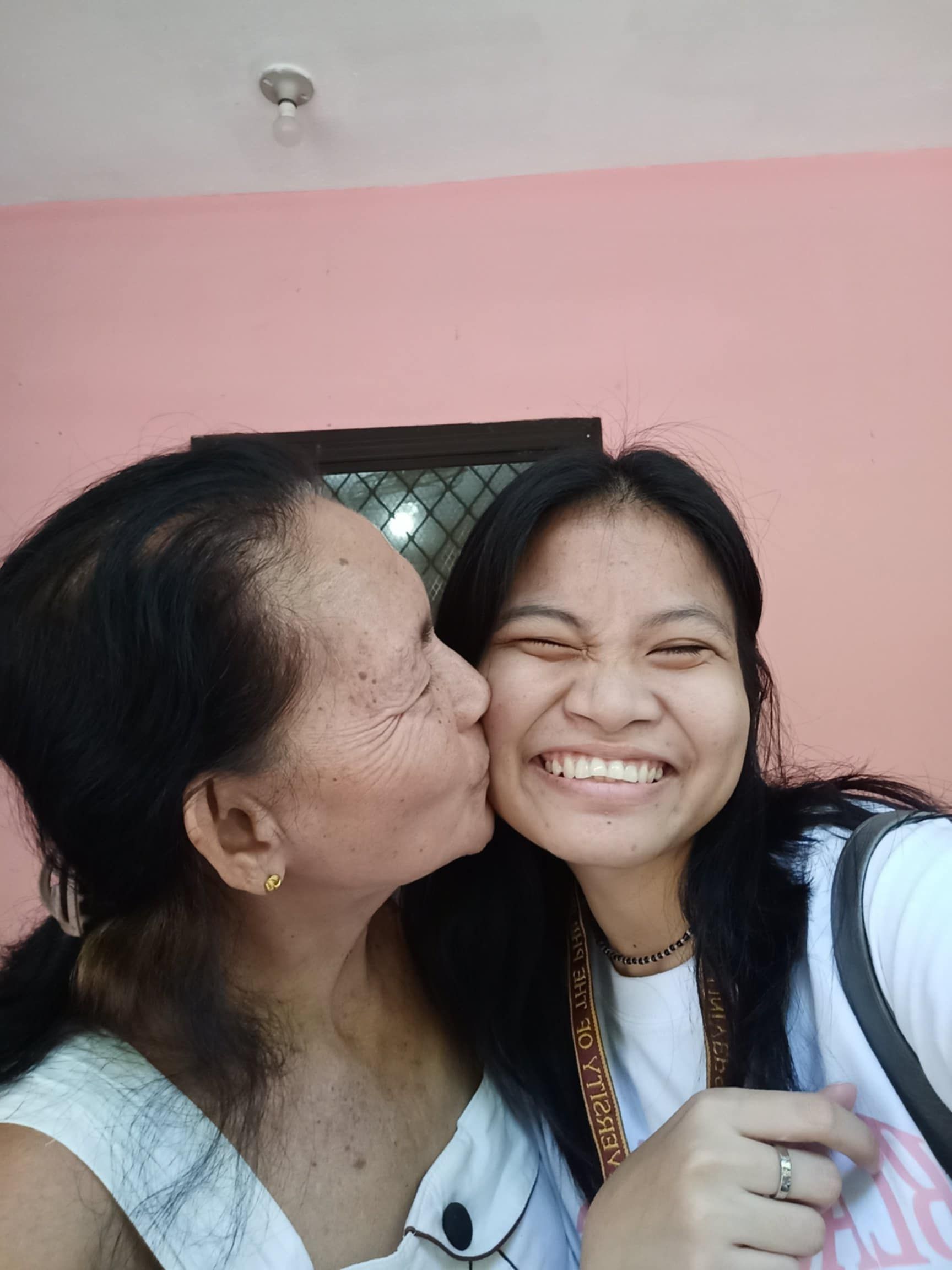 Erlinda Malto gives granddaughter Daneca Pera a kiss. “She’s still mobile but she cannot stand for a very long time,” explains Daneca. “She also has poor eyesight, so she needs a companion, someone to look after her. That’s me.”
