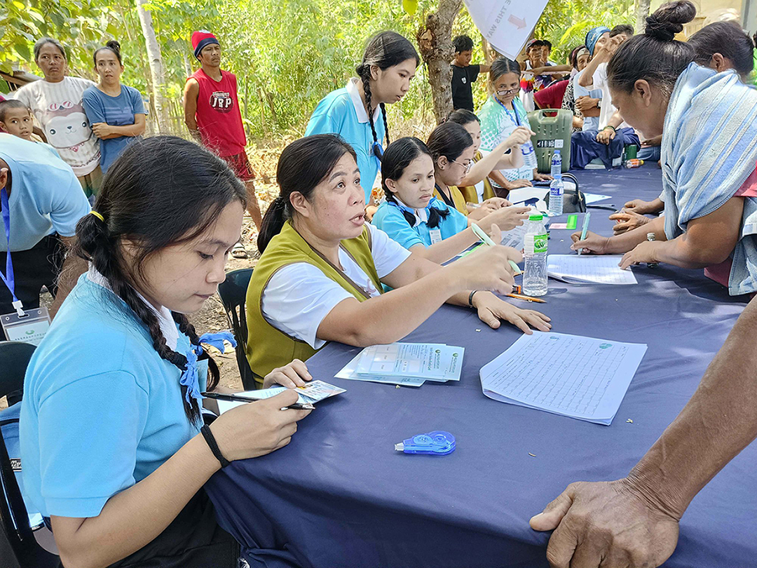 In Barangay Sugal, Jose Abad Santos, Davao Occidental, Mira Pondol (third from left) assists families affected by the magnitude 7.8 quake in June / Photo courtesy of Mira Pondol
