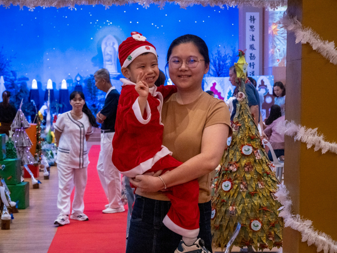 This preschooler is dressed as Santa Claus.