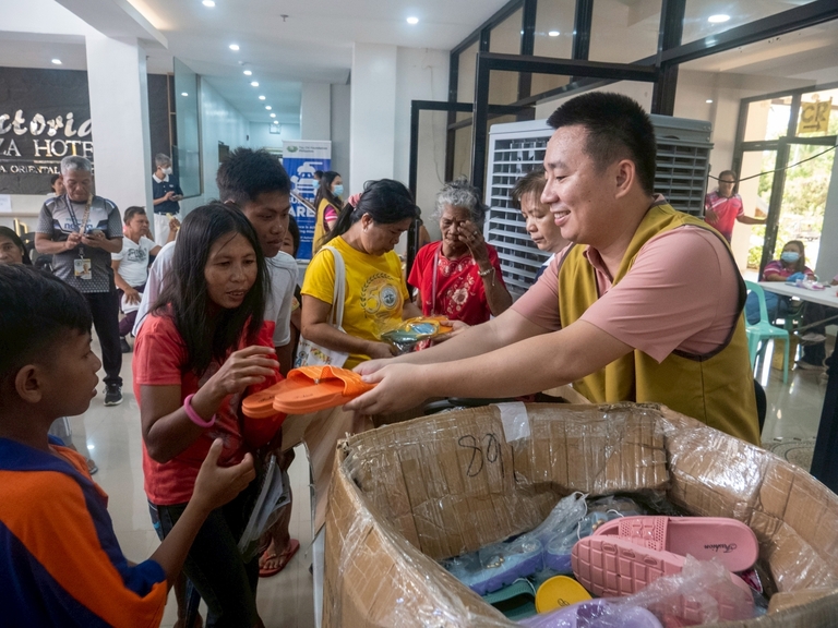 Slippers were distributed while patients waited for their medicines, bringing smiles to their faces.