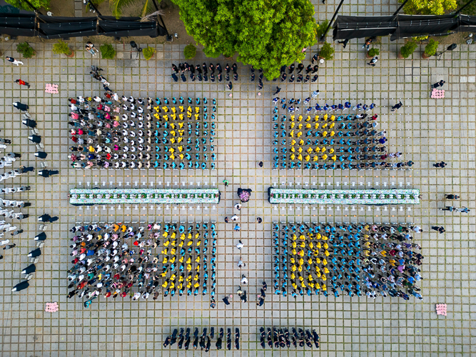 A drone shot of Tzu Chi scholars wearing yellow shirts and caps forms “TC 58,” a reference to Tzu Chi’s 58th year worldwide.