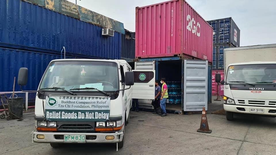 Tzu Chi volunteers load a 2Go container van with bottled water and other relief goods. 2Go pledged the use of seven of its container vans for free to deliver relief goods to Cebu. 