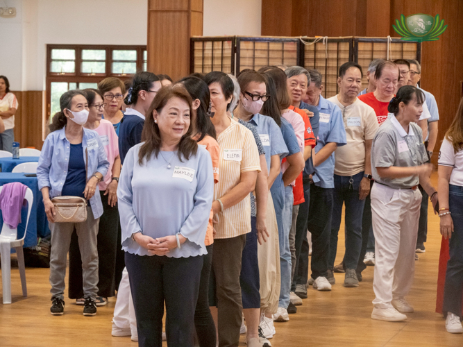 In a fun icebreaker game, grandparents lined up based on different characteristics: height, birthday, number of grandchildren, and age.