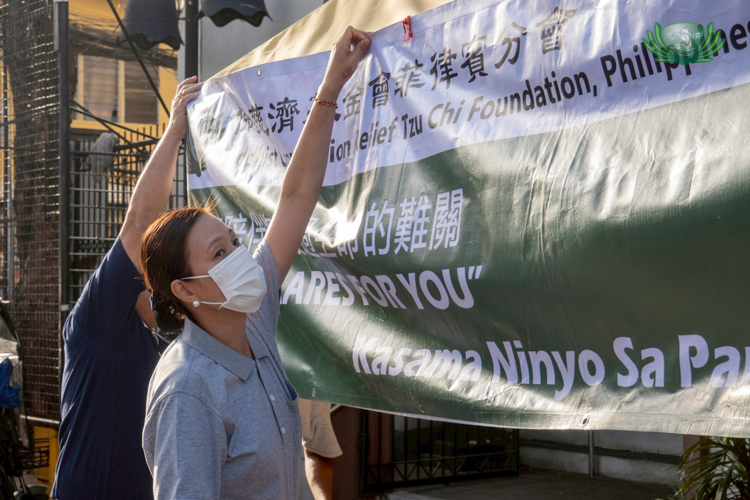 Tzu Chi volunteer Zhenju Yang participates in her first relief operations, helping in many areas such as setting up the venue.